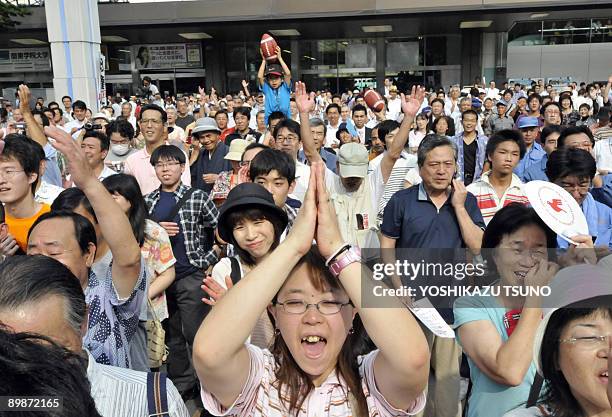 Supporters of Japan's main opposition Democratic Party of Japan cheer for the party leader Yukio Hatoyama and young female candidate Kazumi Ota at a...