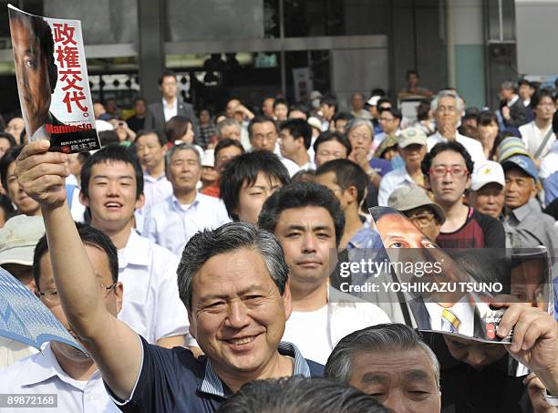 Supporters of Japan's main opposition Democratic Party of Japan cheer for the party leader Yukio Hatoyama and young female candidate Kazumi Ota at a...