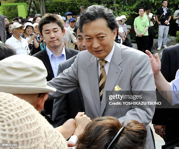 Japan's main opposition Democratic Party of Japan leader Yukio Hatoyama shakes hands with supporters at a rally for his party's young female...