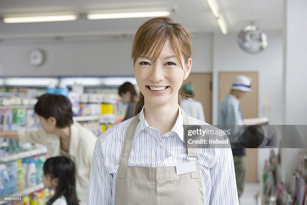 Shop assistant in convinience store, smiling