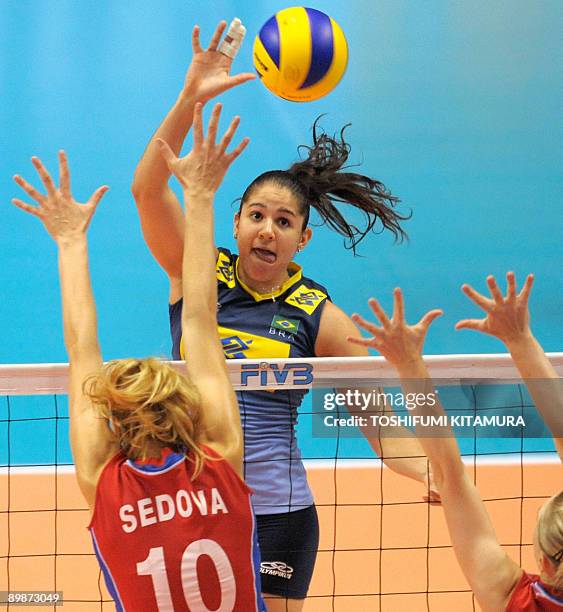 Brazil's Natalia Pereira pushes the ball above Russia's Yulia Sedova during their 2009 FIVB World Grand Prix women's volleyball final round match in...