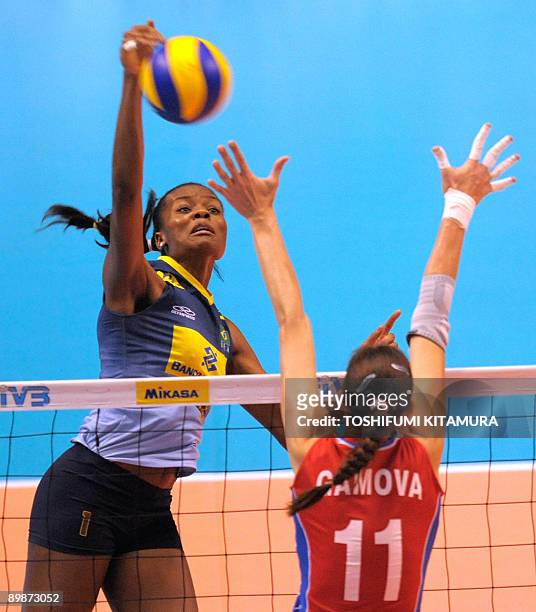 Brazil's Fabiana Claudino spikes the ball past Russia's Ekaterina Gamova during their 2009 FIVB World Grand Prix women's volleyball final round match...