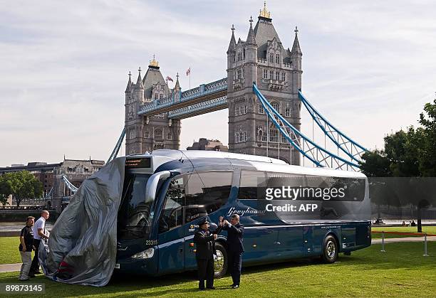 American bus driver Leon Batchelor and Chief Executive of FirstGroup Sir Moir Lockhead unveil one of the new Greyhound buses at the launch of the...