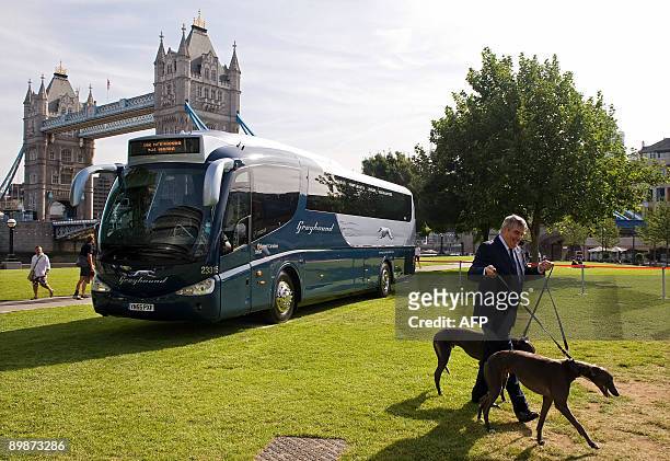 Chief Executive of FirstGroup Sir Moir Lockhead unveils one of the new Greyhound buses at the launch of the service near Tower Bridge, in central...