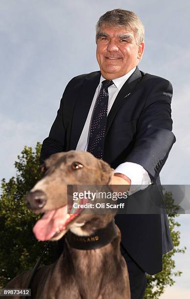 FirstGroup chief executive Sir Moir Lockhead is pictured with a greyhound dog as he unveils the first Greyhound coach to operate in the UK on August...