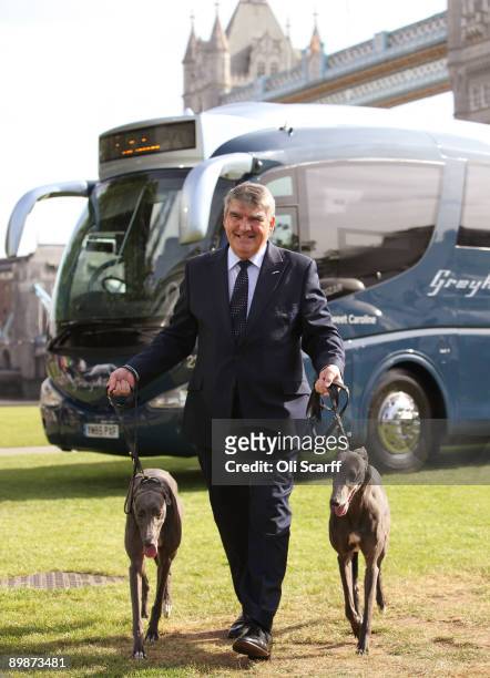 FirstGroup chief executive Sir Moir Lockhead walks with two greyhound dogs as he unveils the first Greyhound coach to operate in the UK on August 19,...