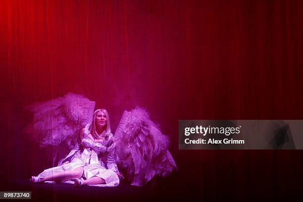 An actress performs on stage at the Aion stand during the 'gamescom', Europe's biggest trade fair for interactive games and entertainment on August...