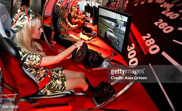 Models pose at the stand of Japanese technology corporate Fujitsu during the 'gamescom', Europe's biggest trade fair for interactive games and...