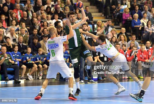 Matthias Musche of SC Magdeburg, Marko Kopljar of Fuechse Berlin and Christian OÂ´Sullivan of SC Magdeburg during the game between Fuechse Berlin and...