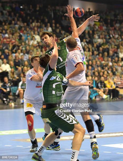 Piotr Chrapkowski of SC Magdeburg, Marko Kopljar of Fuechse Berlin and Zeljko Musa of SC Magdeburg during the game between Fuechse Berlin and SC...