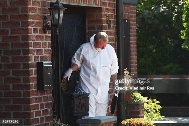 An investigator leaves the crime scene on August 19, 2009 in Schwalmtal near Duesseldorf, Germany. A German pensioner is in police custody after...