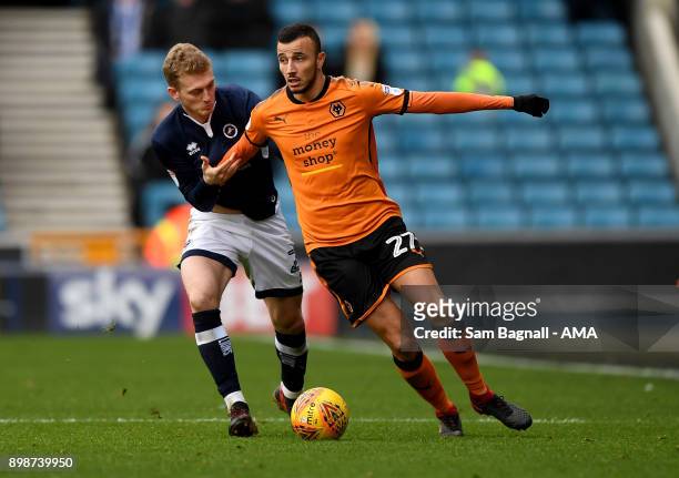 George Saville of Millwall and Romain Saiss of Wolverhampton Wanderers during the Sky Bet Championship match between Millwall and Wolverhampton at...