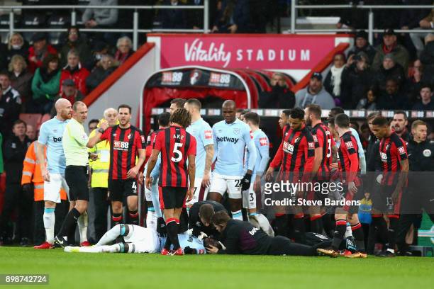 Cheikhou Kouyate of West Ham United receives treatment from the medical team during the Premier League match between AFC Bournemouth and West Ham...