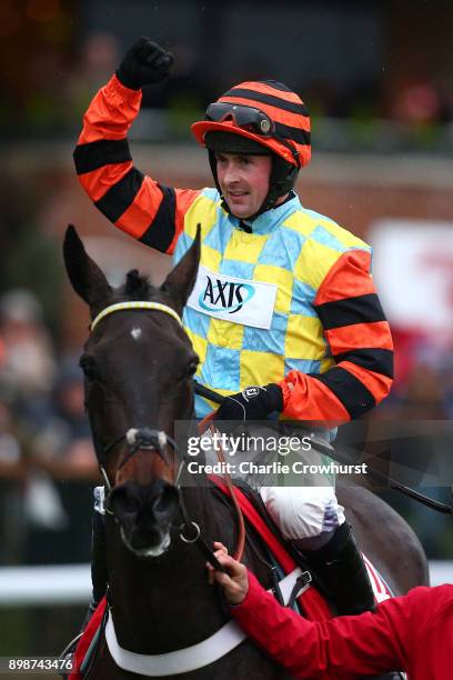 Nico de Boinville celebrates after he ride Might Bite to win The 32Red King George VI Steeple Chase at Kempton Park racecourse on December 26, 2017...