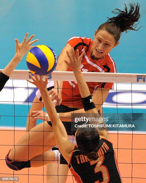 Germany's captain Christiane Furst spikes the ball past Japan's setter Yoshie Takeshita during their 2009 FIVB World Grand Prix women's volleyball...