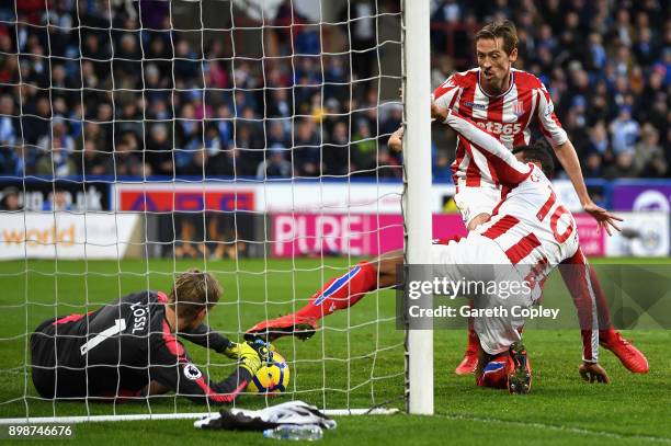 Jonas Lossl of Huddersfield Town saves the ball on the line from an over head kick by Maxim Choupo-Moting of Stoke City during the Premier League...