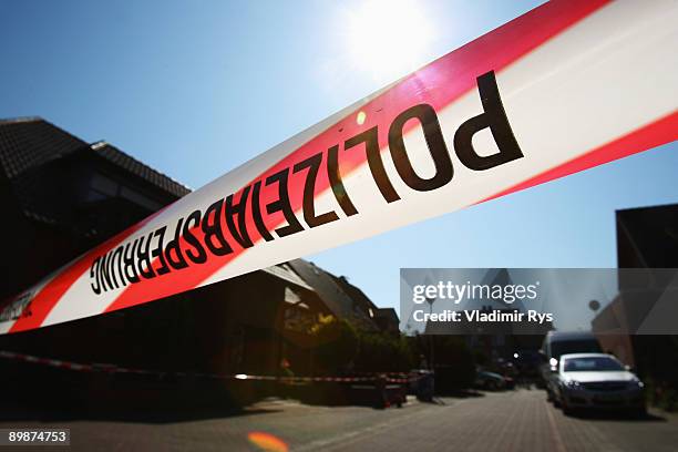 Barrier tape is seen at the crime scene on August 19, 2009 in Schwalmtal near Viersen, Germany. A German pensioner is in police custody after killing...