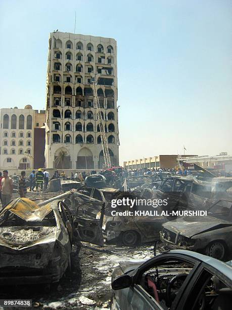 Burnt cars are seen infront of the damaged Iraqi foreign ministry building following a massive explosion in a residential area close to the Green...