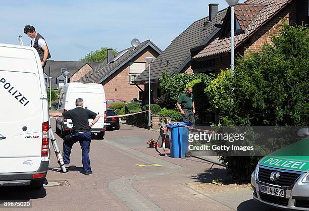 Investigators are seen at the crime scene on August 19, 2009 in Schwalmtal near Viersen, Germany. A German pensioner is in police custody after...