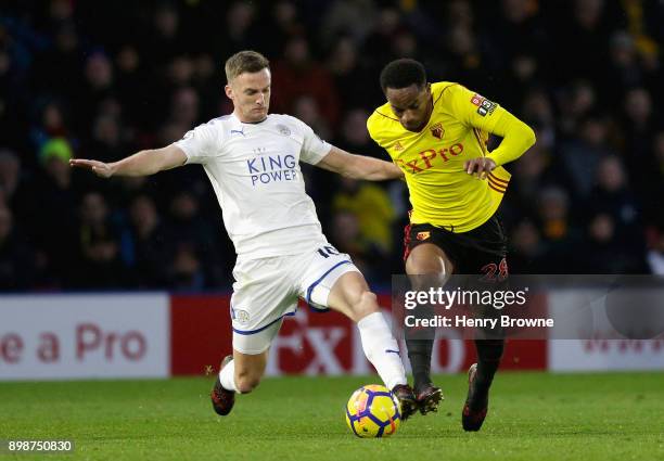 Andy King of Leicester City tackles Andre Carrilo of Watford dduring the Premier League match between Watford and Leicester City at Vicarage Road on...
