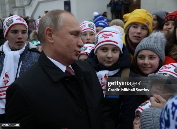 Russian President Vladimir Putin chats with kids at the on December 26, 2017 in the Cathedral Square of Moscow's Kremlin, Russia. Vladimir Putin met...