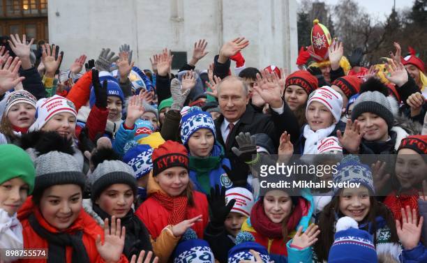 Russian President Vladimir Putin pose for a photo with kids at the on December 26, 2017 in the Cathedral Square of Moscow's Kremlin, Russia. Vladimir...