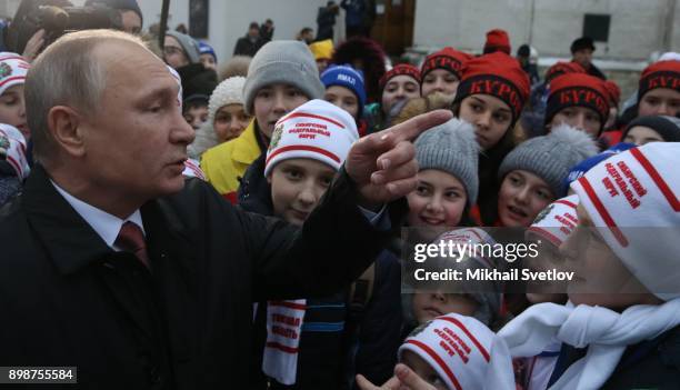 Russian President Vladimir Putin chats with kids at the on December 26, 2017 in the Cathedral Square of Moscow's Kremlin, Russia. Vladimir Putin met...