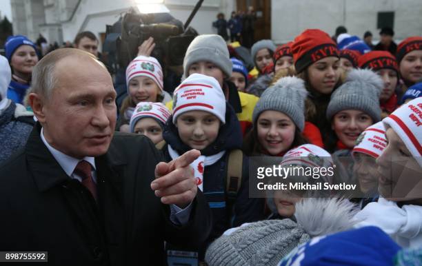 Russian President Vladimir Putin chats with kids at the on December 26, 2017 in the Cathedral Square of Moscow's Kremlin, Russia. Vladimir Putin met...