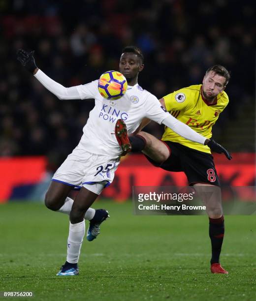 Wilfred Ndidi of Leicester City is challenged by Tom Cleverley of Watford during the Premier League match between Watford and Leicester City at...