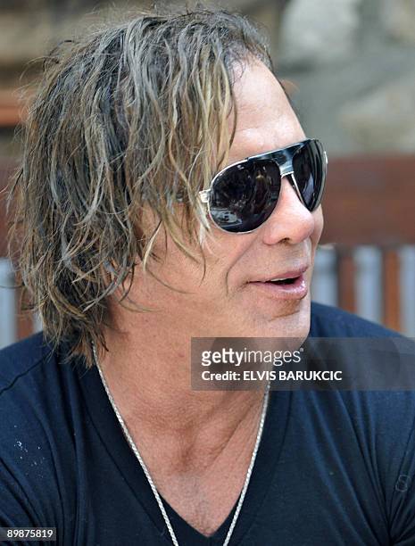 Hollywood US actor Mickey Rourke is pictured with local people during a traditional breakfast at a local ethno restaurant in Sarajevo, on 19 August,...