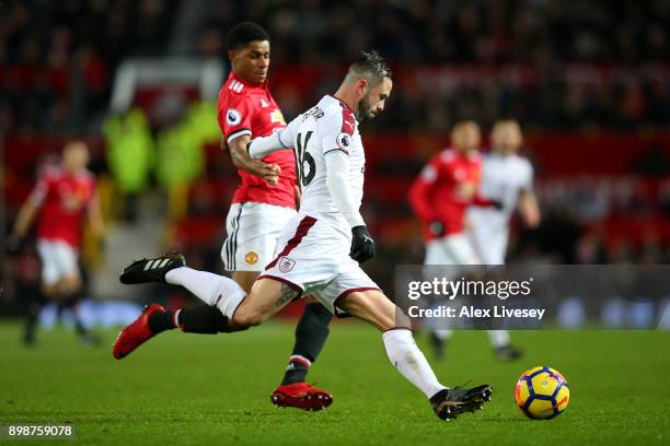 Marcus Rashford of Manchester United tackles Steven Defour of Burnley during the Premier League match between Manchester United and Burnley at Old...