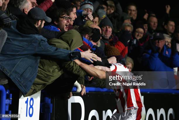 Ramadan Sobhi of Stoke City celebrates with the fans after scoring his sides first goal during the Premier League match between Huddersfield Town and...
