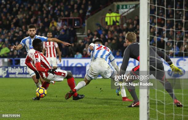 Mame Biram Diouf of Stoke City is tackled by Christopher Schindler of Huddersfield Town in the penalty area but no penalty is awarded during the...