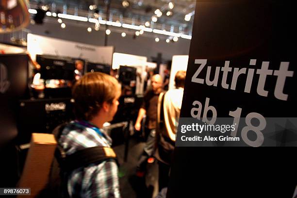 Visitor enters the adults area at the Playstation stand of Japanese electronic corporate Sony during the 'gamescom', Europe's biggest trade fair for...