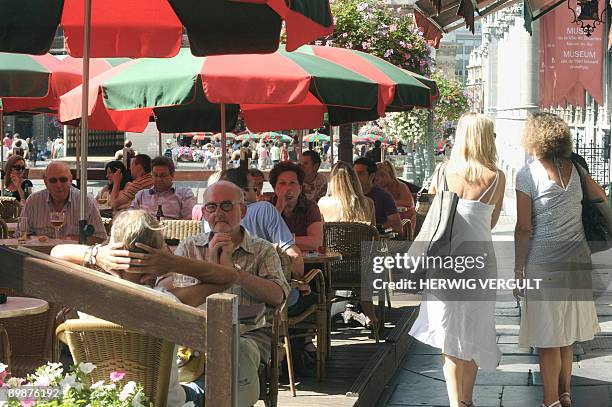 Residents and tourists enjoy a drink on the terrace of the Brussels Grand Place - Grote Markt, on August 19, 2009 as temperatures reached 30 degrees...