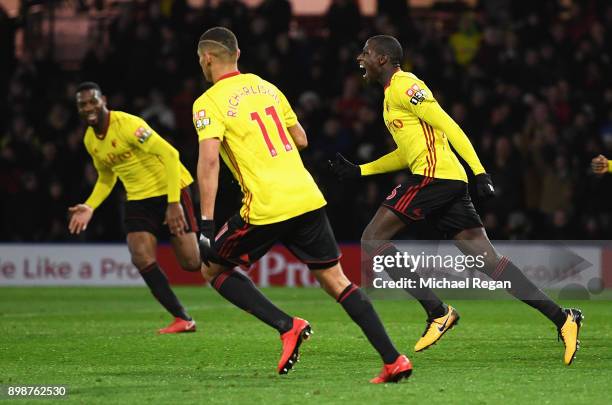 Abdoulaye Doucoure of Watford celebrates the own goal scored by Kasper Schmeichel of Leicester City with team mates during the Premier League match...