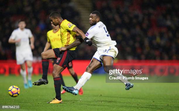 Wes Morgan of Leicester City in action with Marvin Zeegelaar of Watford during the Premier League match between Watford and Leicester City at...