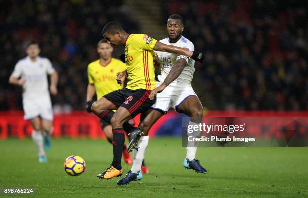 Wes Morgan of Leicester City in action with Marvin Zeegelaar of Watford during the Premier League match between Watford and Leicester City at...