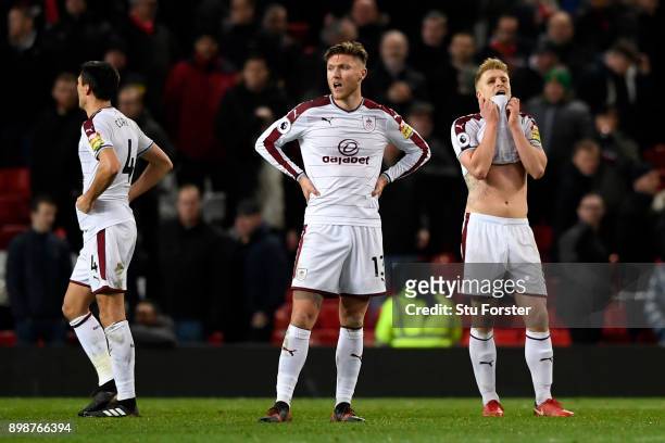 Jeff Hendrick, Ben Mee and Jack Cork of Burnley look dejected on the final whistle during the Premier League match between Manchester United and...