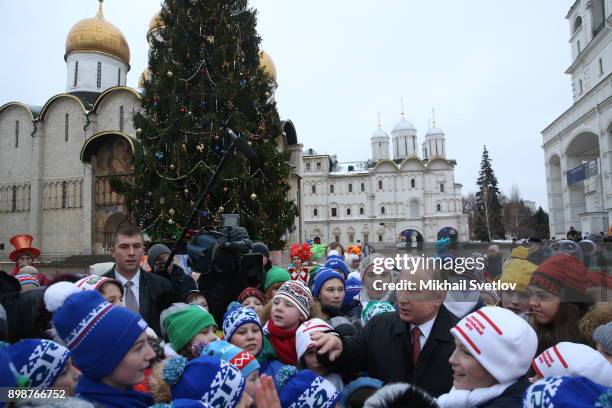 Russian President Vladimir Putin chats with kids at the Cathedral Square of Moscow's Kremlin, Russia, December 2017. Vladimir Putin met children from...