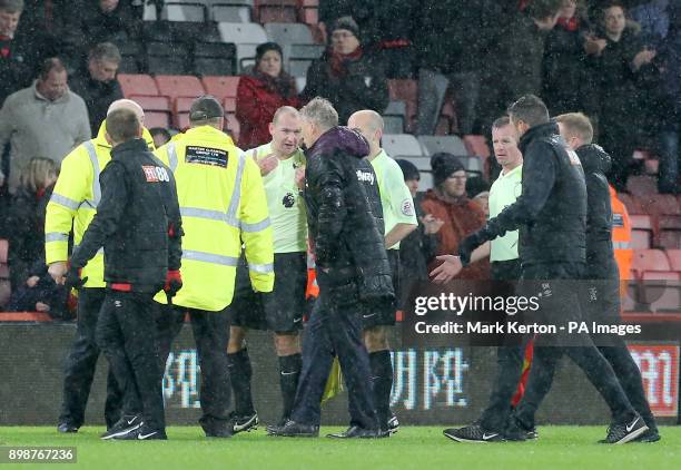 Match referee Bobby Madley speaks to West Ham United manager David Moyes after the final whistle during the Premier League match at the Vitality...