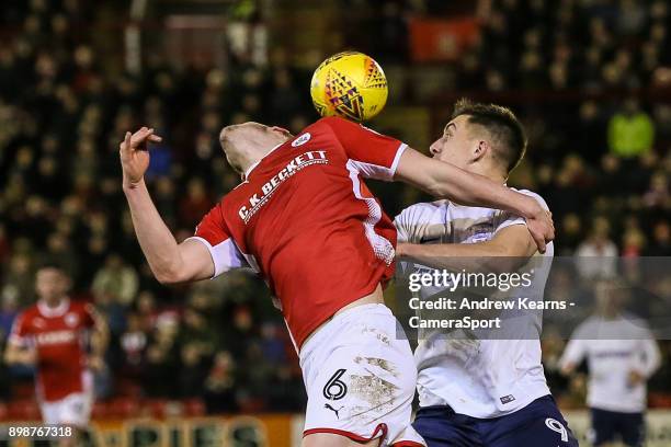 Preston North End's Jordan Hugill competing with Barnsley's Liam Lindsay during the Sky Bet Championship match between Barnsley and Preston North End...