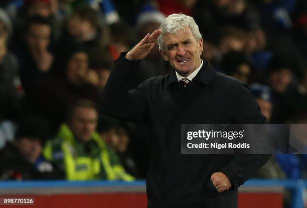 Mark Hughes, Manager of Stoke City shows appreciation to the fans after the Premier League match between Huddersfield Town and Stoke City at John...