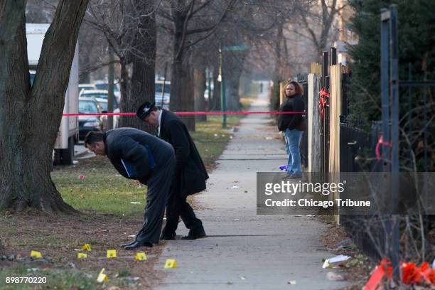 Woman watches police investigate the scene of a shooting that happened in the 5200 block of West Ferdinand Street on Saturday, Dec. 23, 2017 in the...