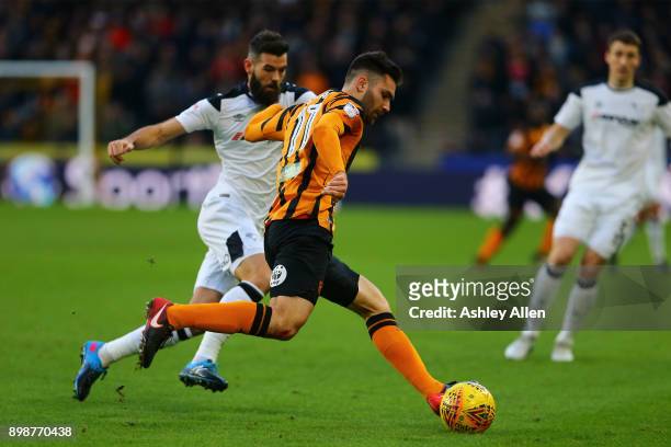 Joe Ledley of Derby County challenges Jon Toral of Hull City as he clears the ball during the Sky Bet Championship match between Hull City and Derby...