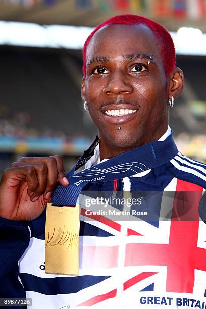 Phillips Idowu of Great Britain & Northern Ireland receives the gold medal during the medal ceremony for the men's Triple Jump Final during day five...