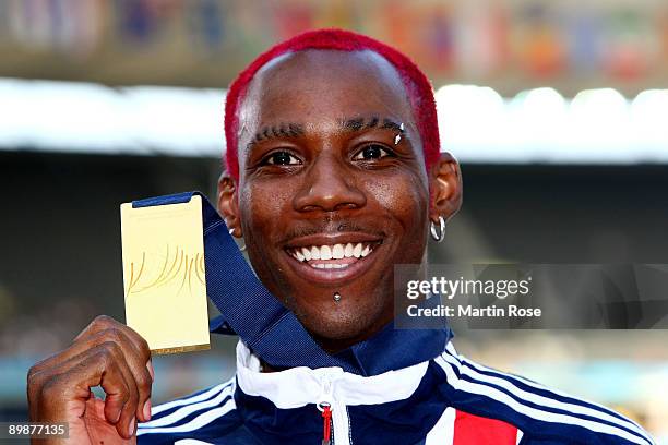 Phillips Idowu of Great Britain & Northern Ireland receives the gold medal during the medal ceremony for the men's Triple Jump Final during day five...