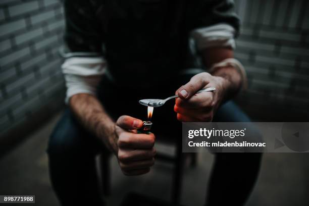 preparing his dose - heroin addict arm stock pictures, royalty-free photos & images