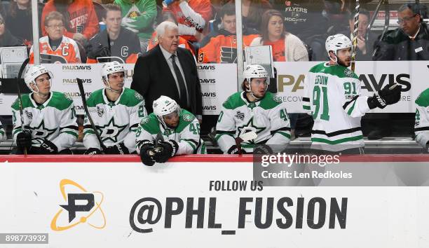 Head Coach Ken Hitchcock of the Dallas Stars watches the play on the ice behind Tyler Pitlick, Antoine Roussel, Gemel Smith, Remi Elie and Tyler...