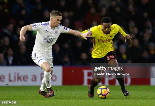 Andy King of Leicester City tackles Andre Carrilo of Watford dduring the Premier League match between Watford and Leicester City at Vicarage Road on...